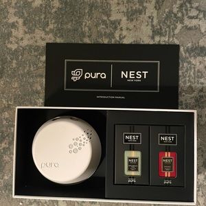 - New in box Pura device with 2 nest holiday fragrances
